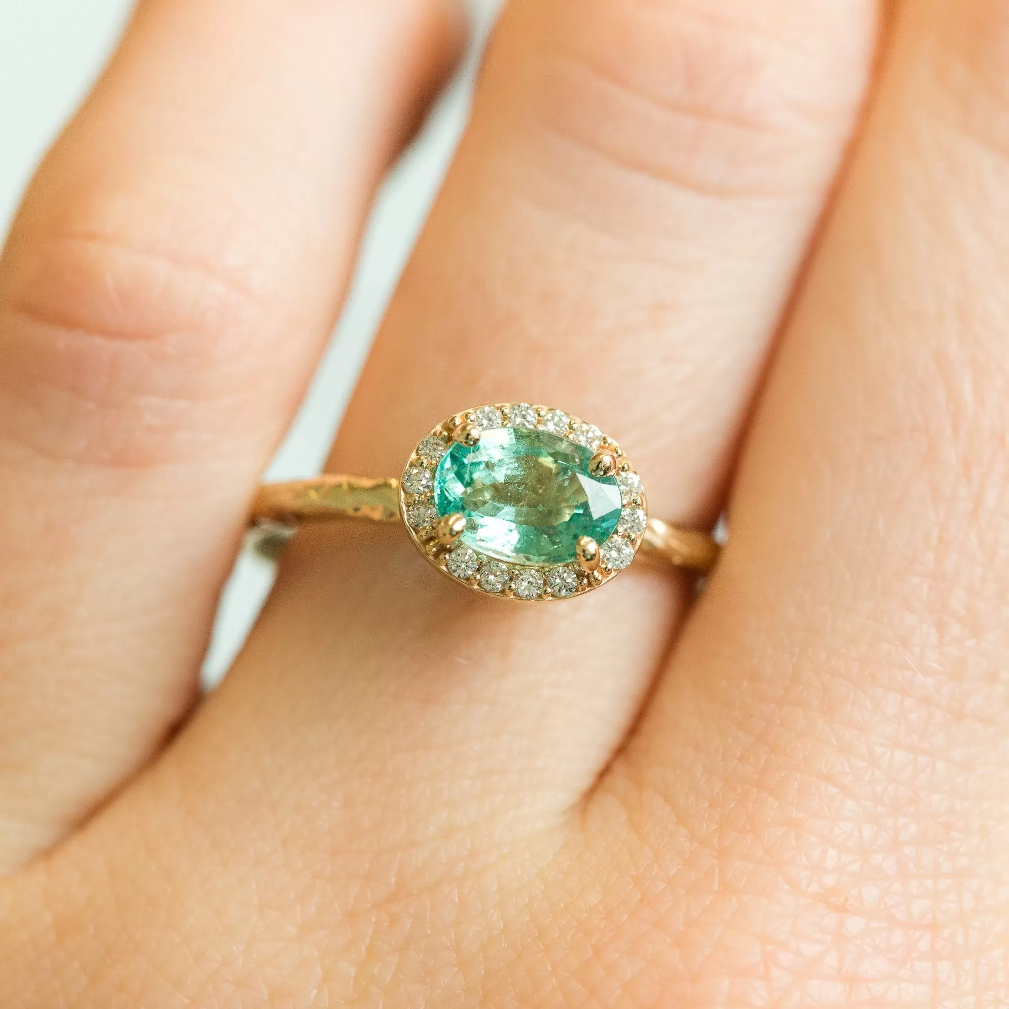 Neon Emerald East-West Oval Halo Ring in Evergreen Carved Yellow Gold